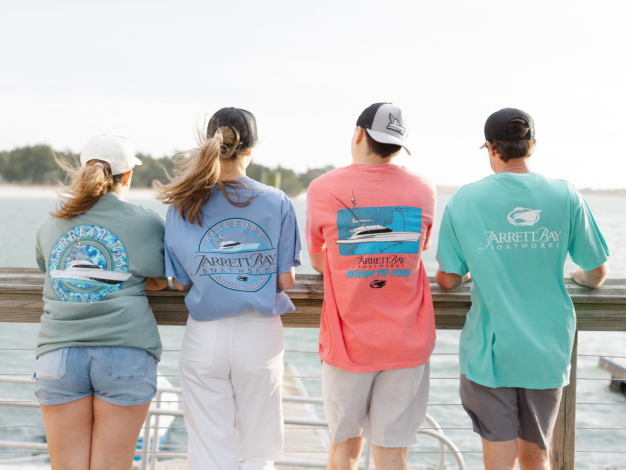 2 women and 2 men overlooking a dock wearing Jarrett Bay gear