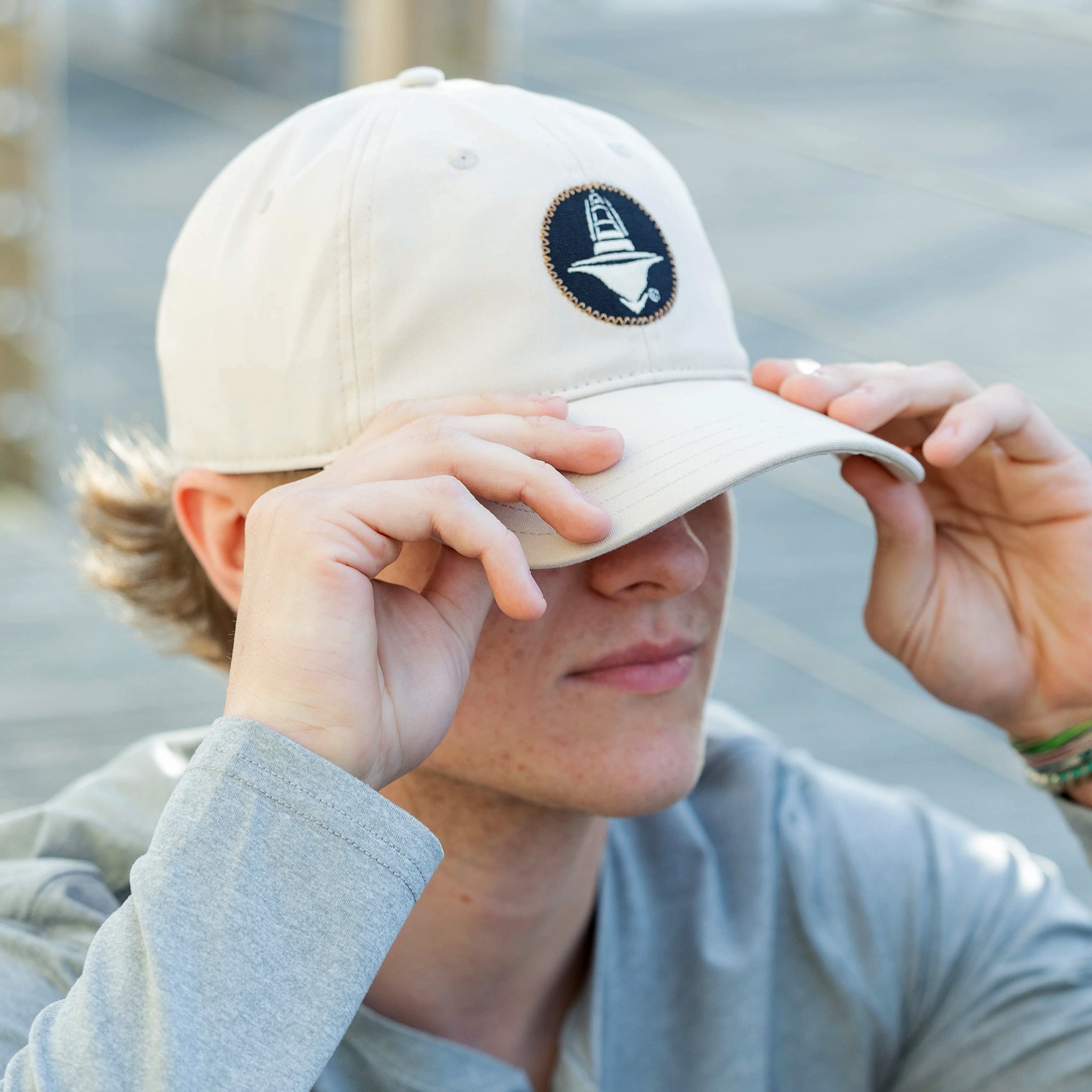 Man models a Jarrett Bay Flare Badge Birch Twill Hat